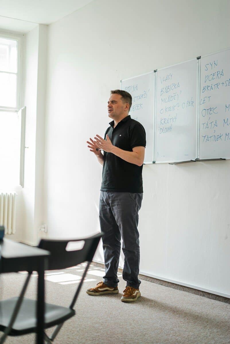 a person standing in front of a whiteboard